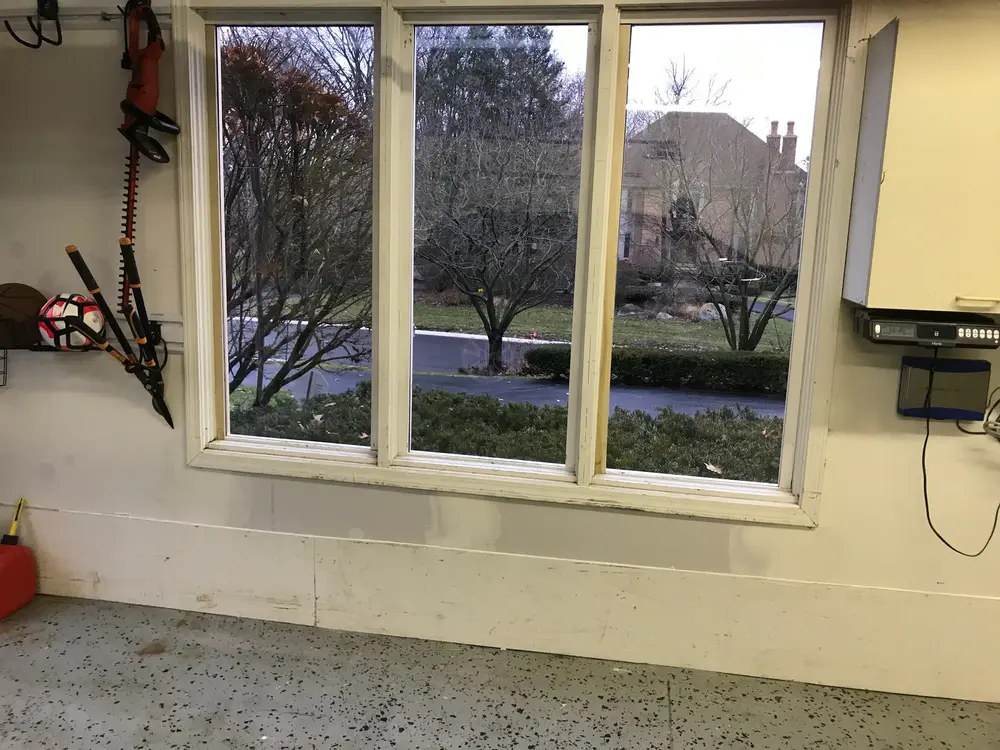 Three-pane window seen from inside a garage