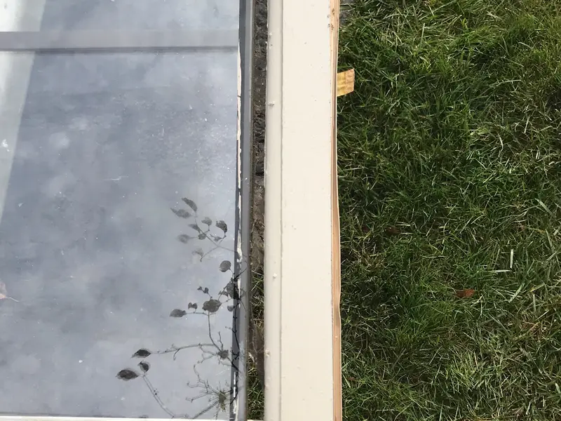 Window sash laid flat on the grass during repair