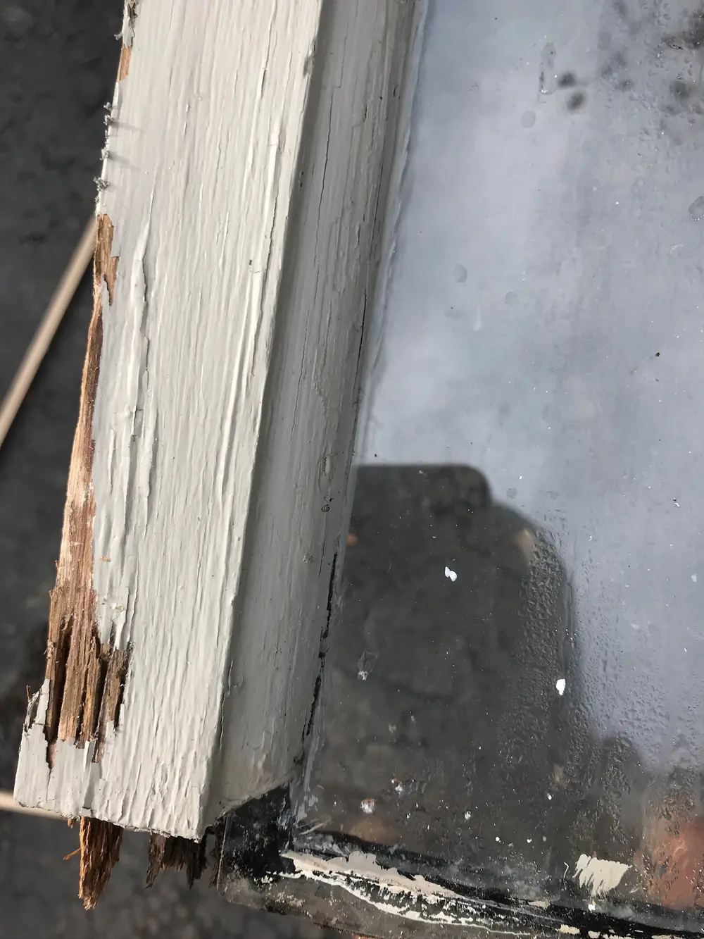 Close-up of rotted wood on the corner of a window sash