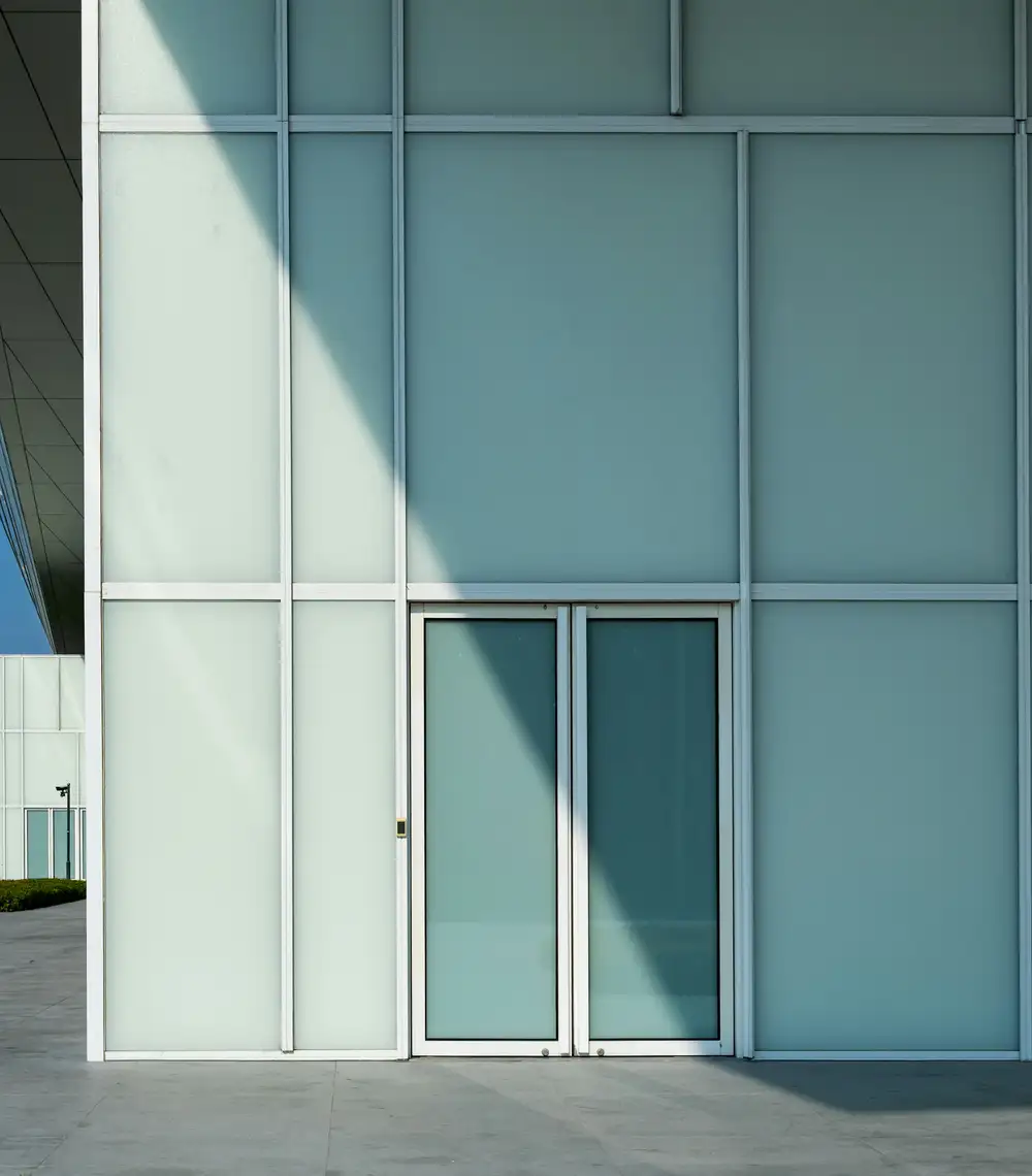 Glass storefront facade with aluminum framing and double glass doors